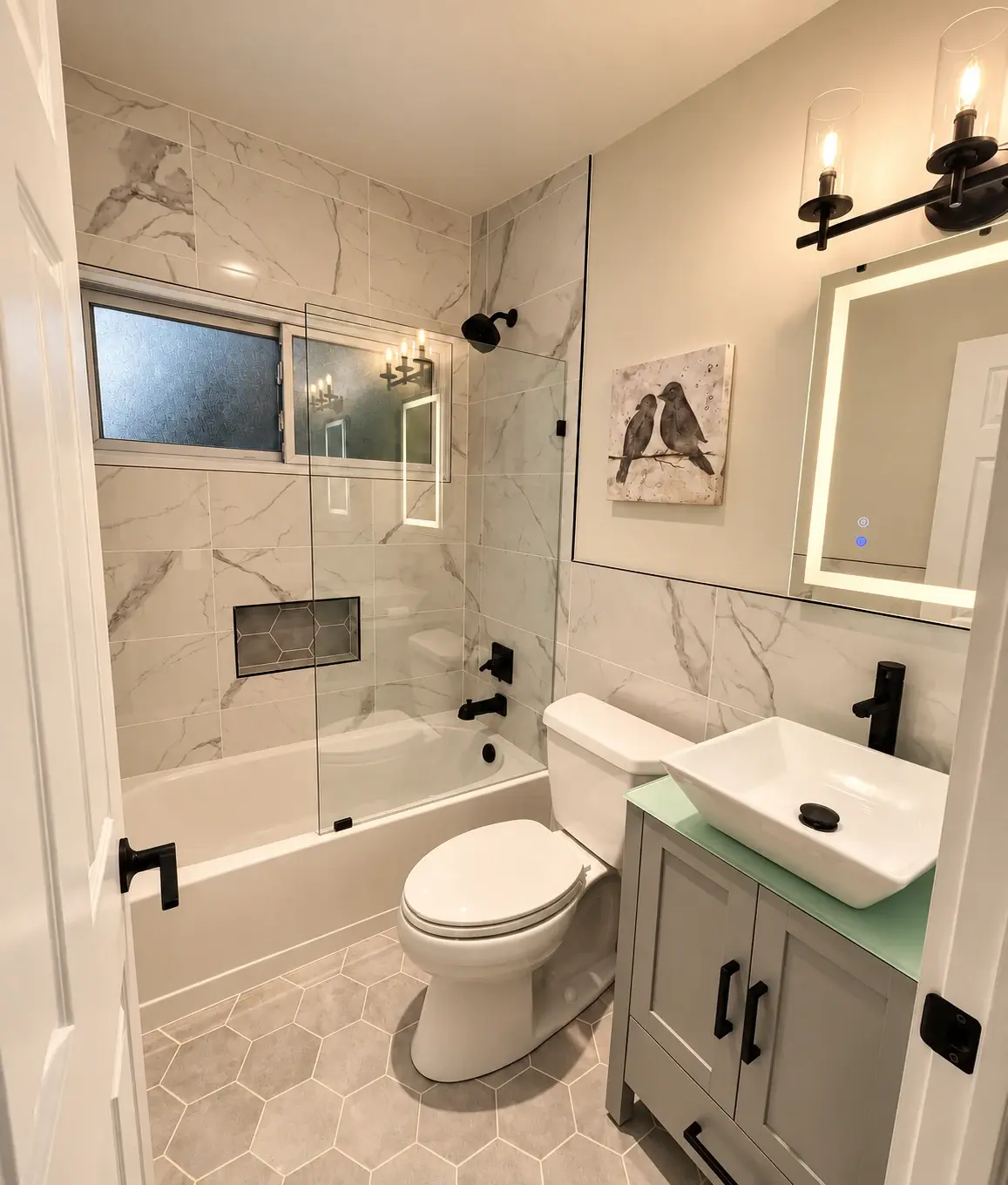Thoughtful details, daily comfort: A glass shower enclosure, hexagonal floor tile and a coloured vanity bring personality to a compact bathroom.