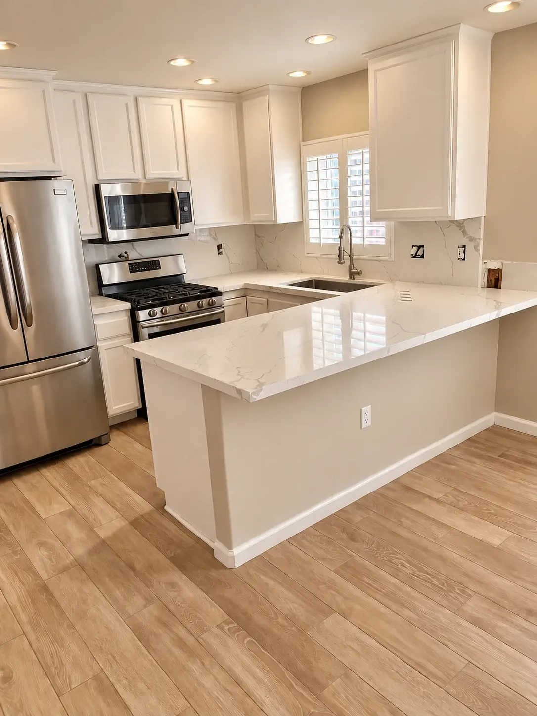 Clean lines, open possibilities: White cabinetry and counters pair with stainless steel appliances and warm wood-look flooring.