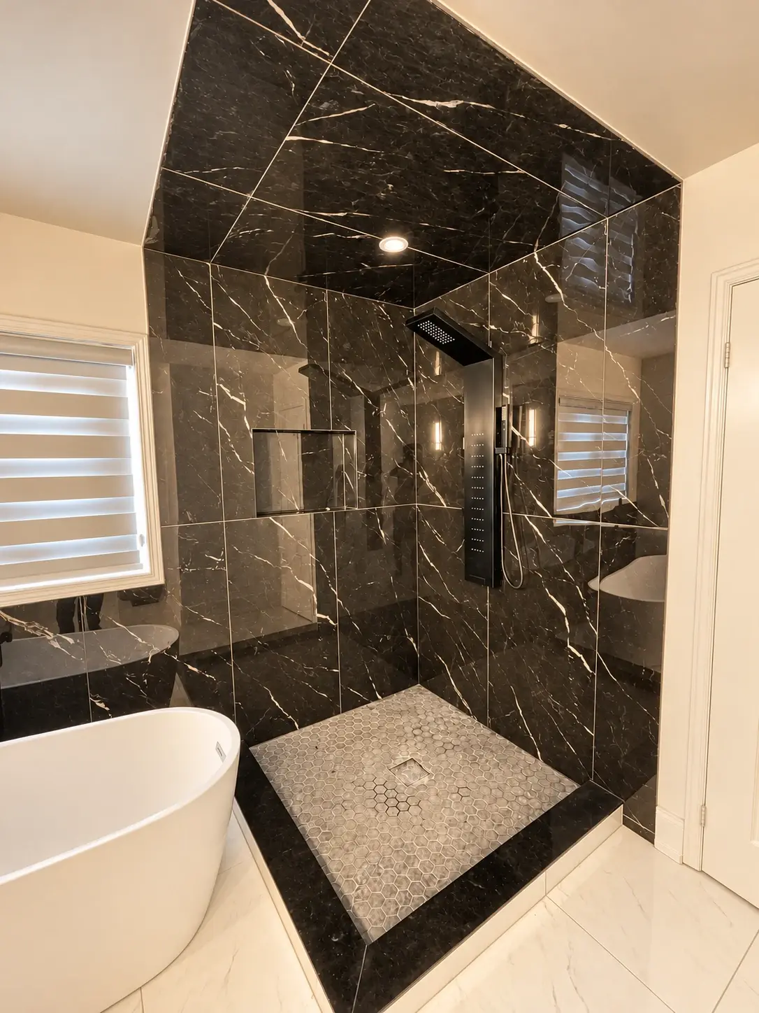 Contrast with character: Dark marble-look tiles define an open shower alongside a freestanding white tub.